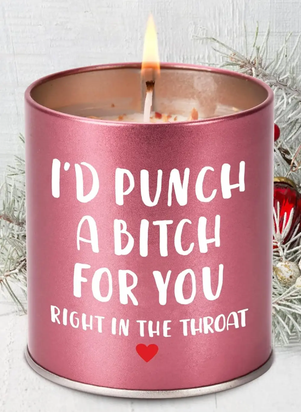 Pink canister candle with the phrase 'I'd punch a bitch for you right in the throat,' featuring a long-lasting burn and pleasant scent.